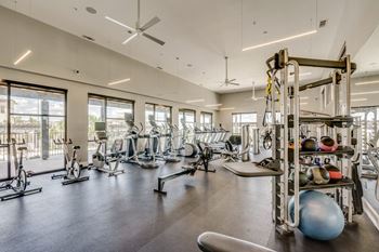 fitness center with weights at Berkshire Santal apartments